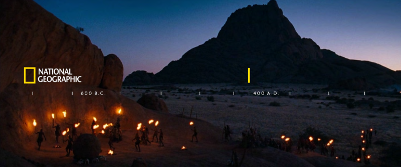 national geographic branded image of people gathering at night with flame torches in the mountains 